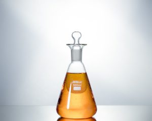 clear glass bottle with brown liquid